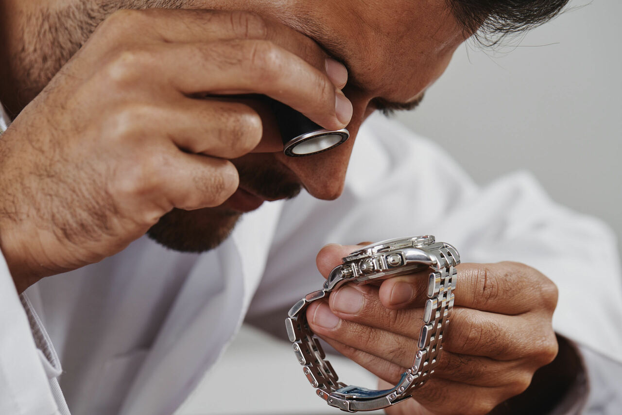 A man examining a watch